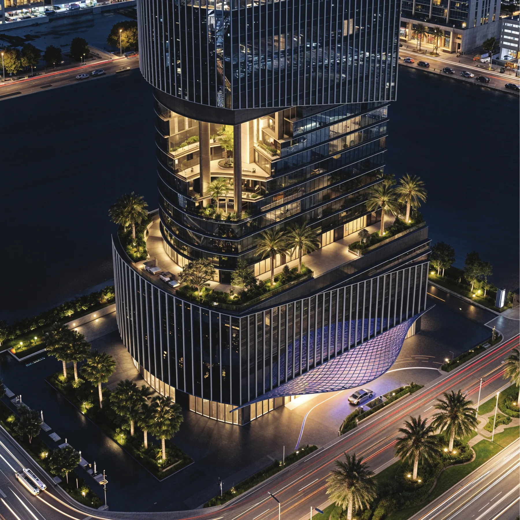 Aerial night view of the 1970 office tower podium and sky garden terraces in Al Habtoor City Dubai